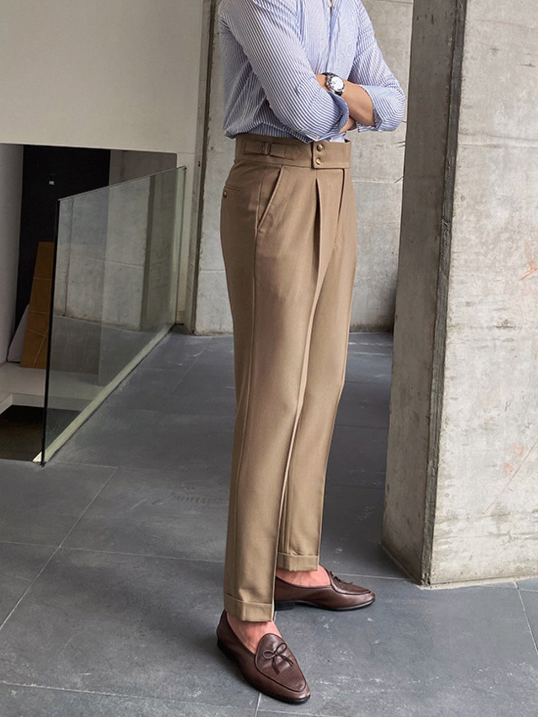 Detail of the extended waist tab and buckle on men's Gurkha pants, showing quality tailoring.