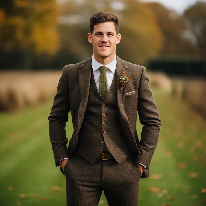Back view of a tailored olive green men's three-piece suit. Elegant formal wear for a wedding guest.