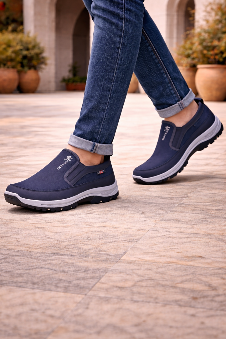 Front view of men's gray orthopedic slip-on walking shoes, featuring arch support & a cushioned sole for outdoor comfort.