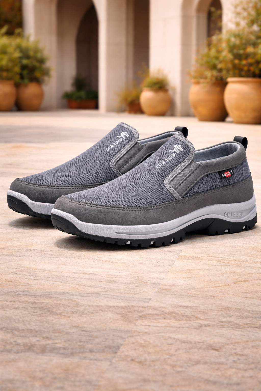Breathable men's active slip-on walking shoes with orthopedic design, providing cushioned comfort & support for outdoor trails.