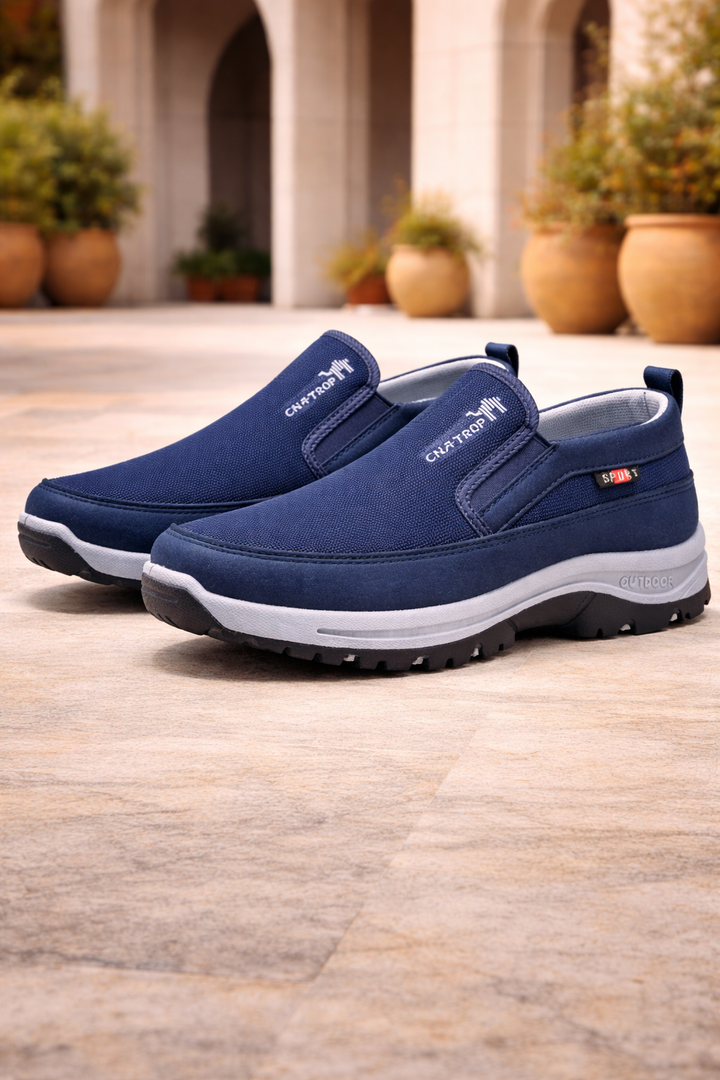 Side profile of men's slip-on walking shoes, highlighting the orthopedic arch support and cushioned sole for comfort.