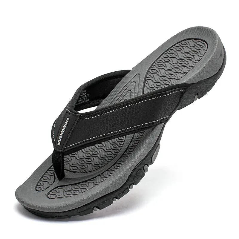 Grippy sole on men's textured flip-flops, perfect for outdoor summer activities. Cushioned comfort.