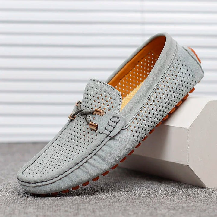 Men's fashionable perforated slip-on loafers, ideal breathable footwear for smart casual summer style.