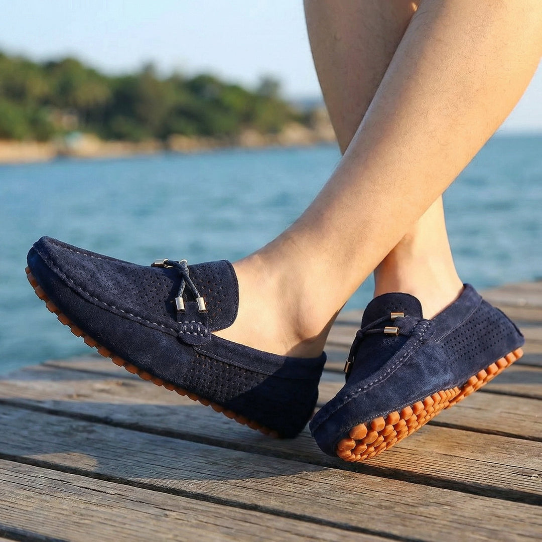 Close-up of men's brown perforated slip-on loafers, perfect for warm weather comfort & casual elegant fashion.