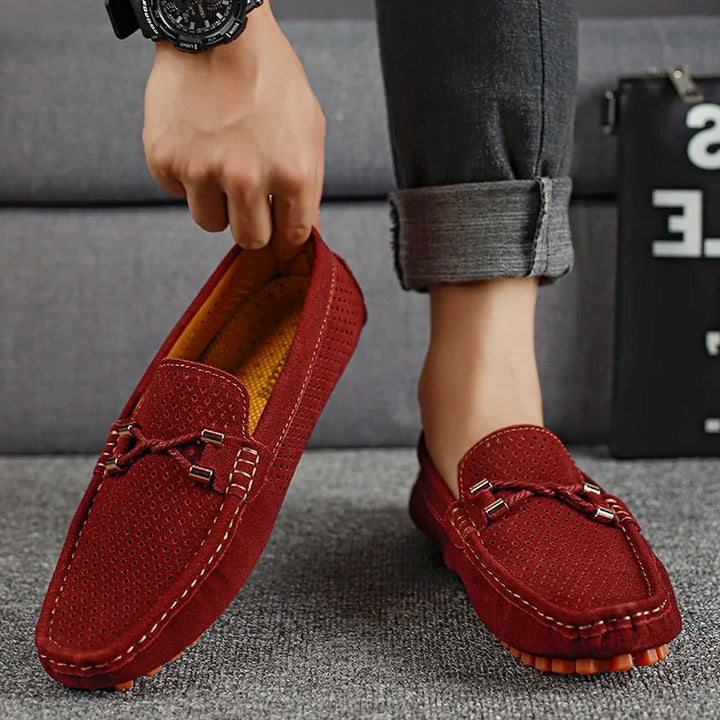 Stylish men's navy perforated slip-on loafers, offering breathable footwear for summer fashion & casual wear.