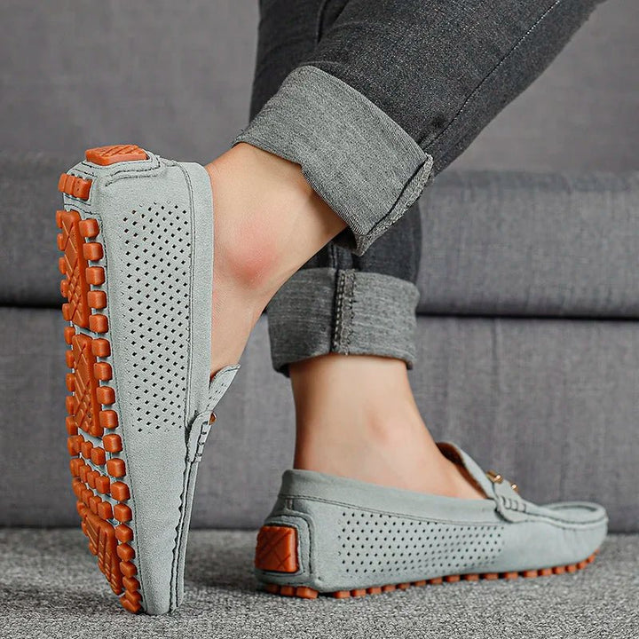 High-angle view of men's breathable perforated slip-on loafers, essential for summer fashion.