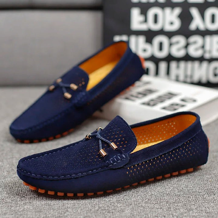 Side view of men's classic perforated slip-on loafers, a staple for warm weather & dress casual style.