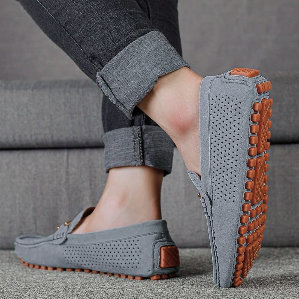 Close-up of men's perforated slip-on loafer texture, highlighting breathable design for comfortable summer shoes.