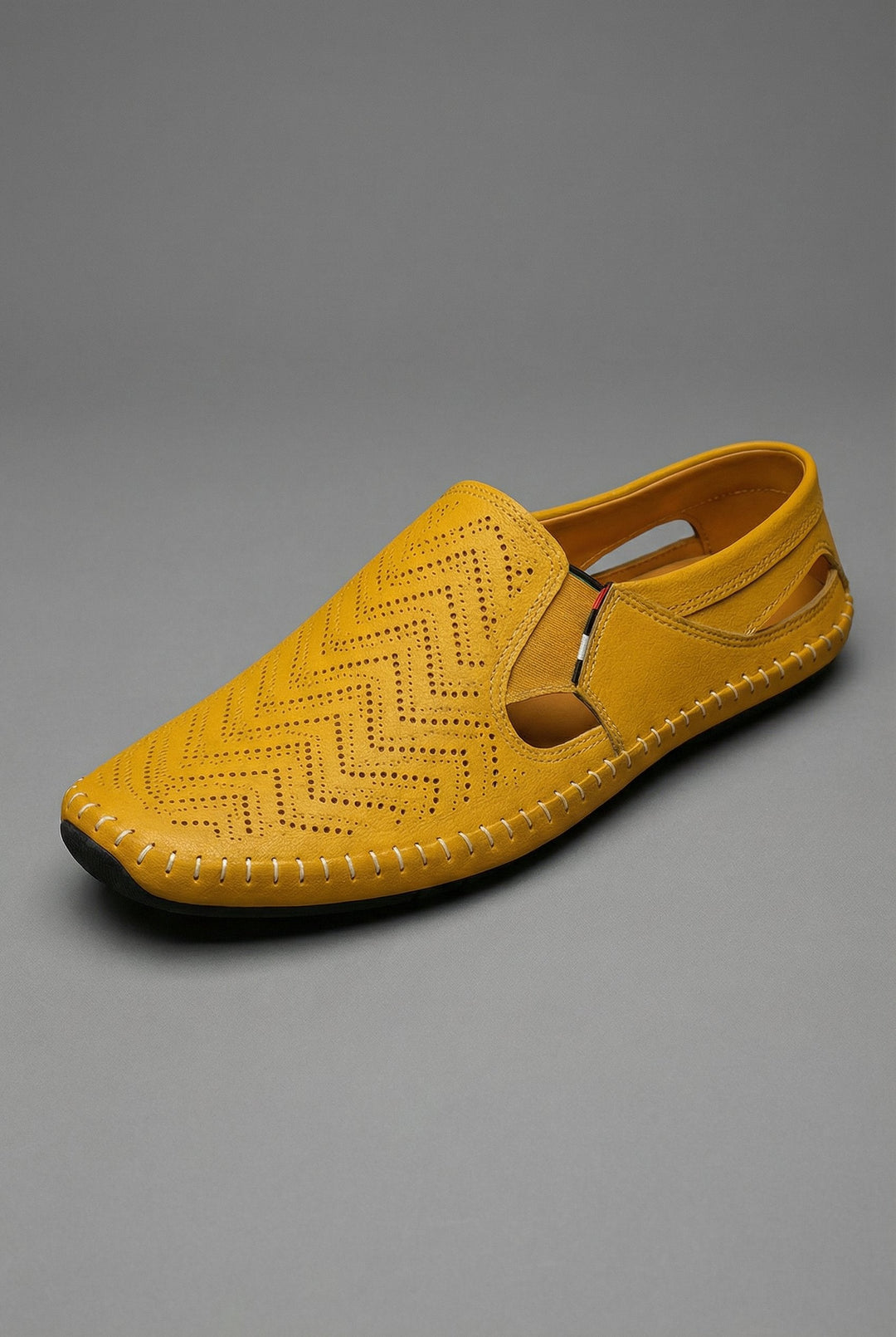 Perforated men's loafers for breathability, sleek slip-on design ideal for smart-casual footwear.
