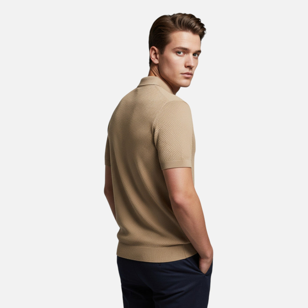 Man wearing a stylish men's pineapple print polo shirt, perfect for a relaxed summer day.