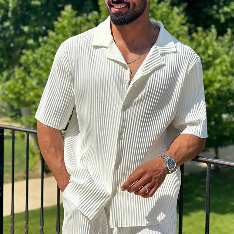 Relaxed fit men's pleated short sleeve shirt and matching straight leg trousers. Smart casual summer outfit.