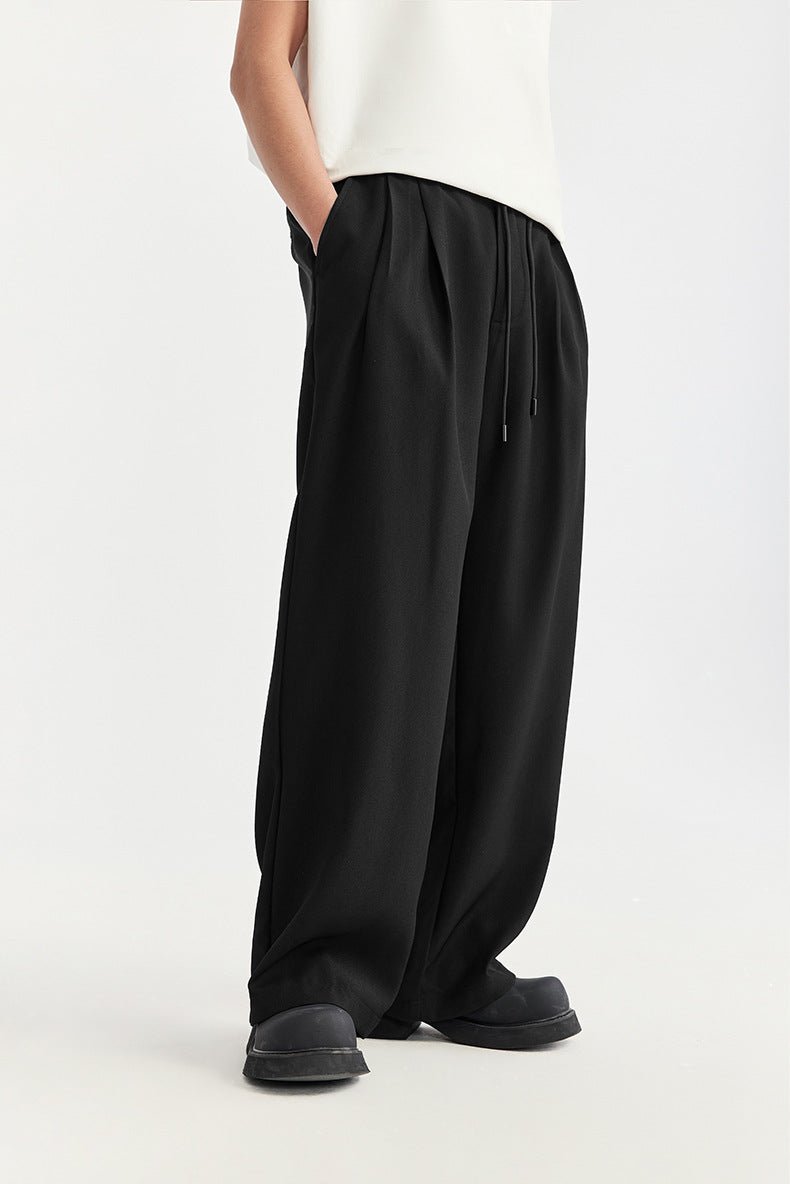 Men's pleated wide leg drawstring trousers. Relaxed fit for modern comfort & casual style.