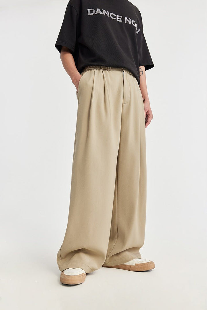 Relaxed fit men's wide leg trousers. Features pleats & drawstring for versatile casual fashion.