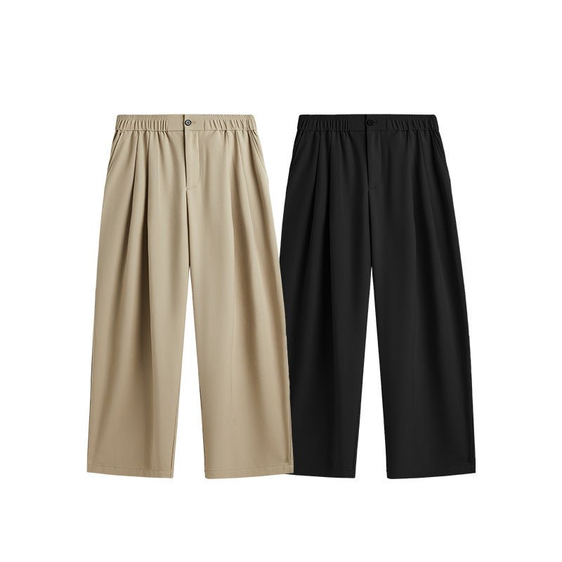 Close-up of men's wide leg pleated drawstring trousers showing fabric texture & details.