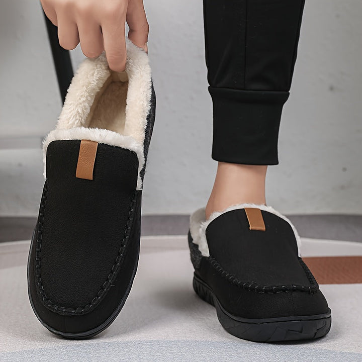Stylish men's indoor slippers, plush and warm, with a protective non-slip sole for cozy footing.