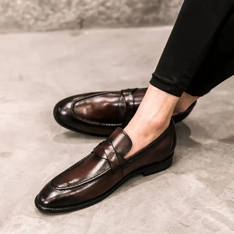 Sophisticated men's polished slip-on penny loafers. Elegant formal and smart casual shoes for a refined work look.