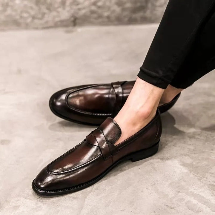Sophisticated men's polished slip-on penny loafers. Elegant formal and smart casual shoes for a refined work look.
