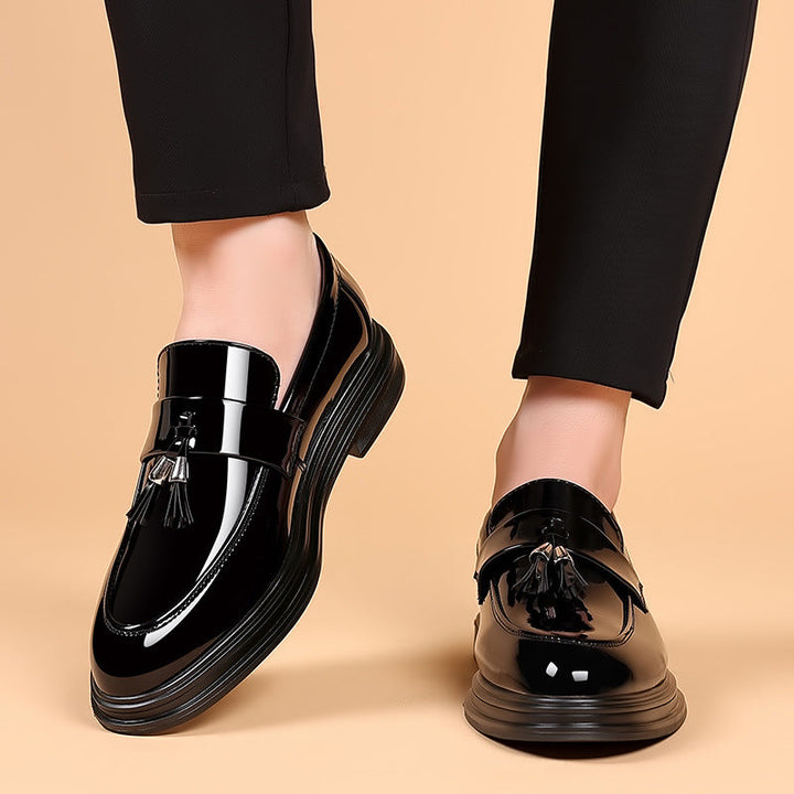 Men's polished black leather tassel penny loafers, classic slip-on dress shoes for formal & business events.