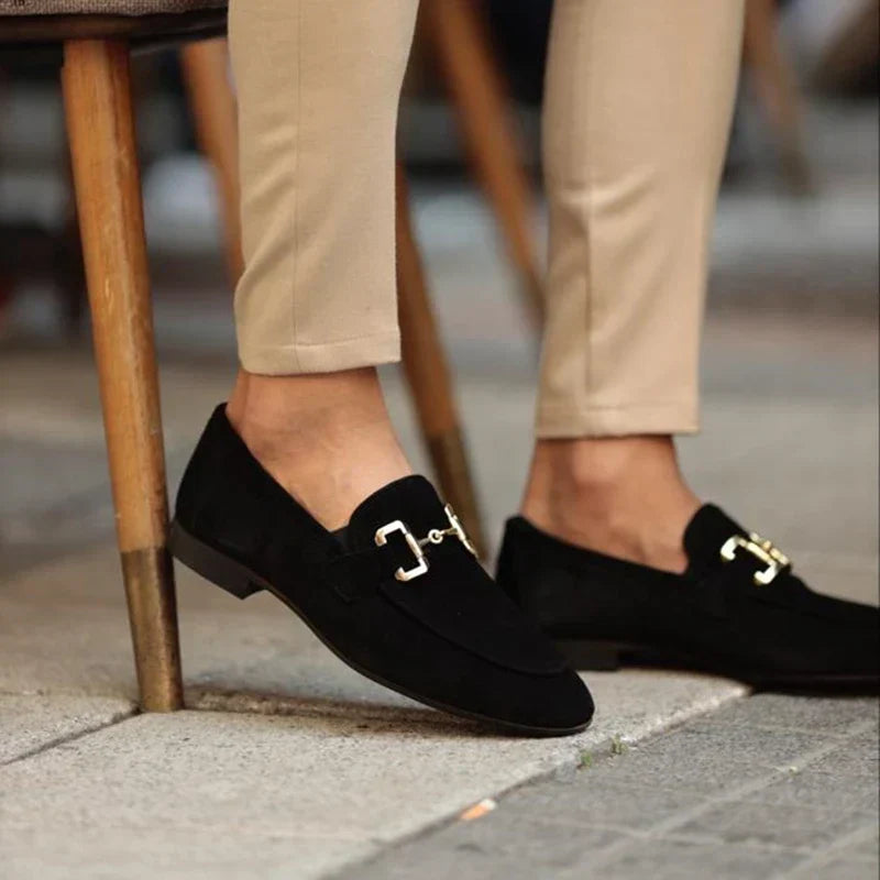 Close-up of men's polished black horsebit loafers, showcasing the sleek design and polished finish.