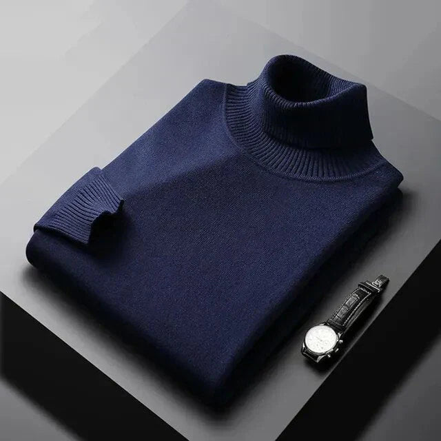 Stylish man modeling a premium grey turtleneck jumper. Elegant, warm men's knitwear for winter fashion.