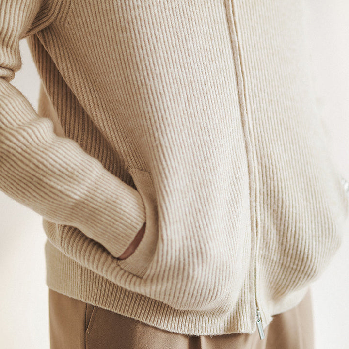 Close-up of a men's ribbed zip cardigan sweater, highlighting the premium knit and stand collar detail.