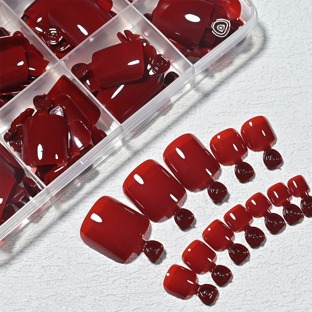 Stylish red press-on toenails for men, offering a quick and easy at-home pedicure. Perfect for men's grooming.