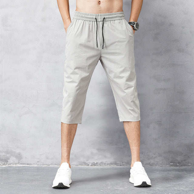 Men's quick-dry long swim shorts in blue, perfect for beach, pool, and summer vacation. Ideal men's swimwear.