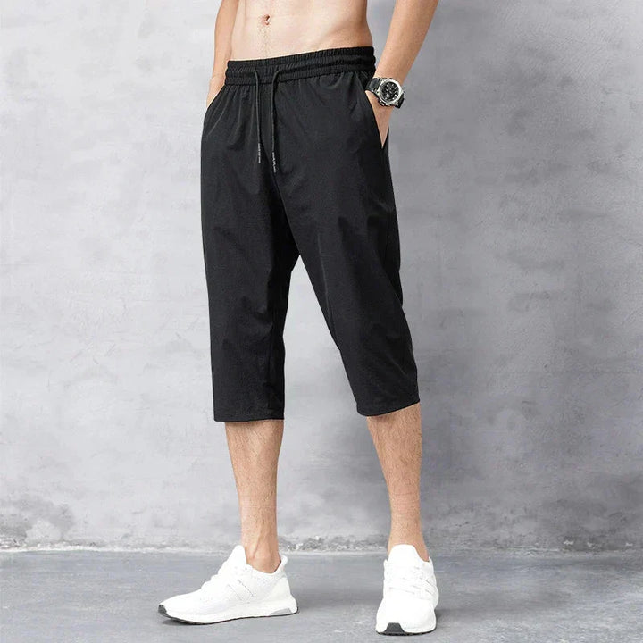 Back view of men's comfortable long quick-dry swim shorts in grey, great for pool, beachwear, and active summer days. Vacation shorts.