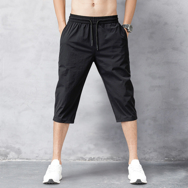 Collection of men's long quick-dry swim shorts in various colors, essential for beach, pool, and summer water activities. Men's apparel.