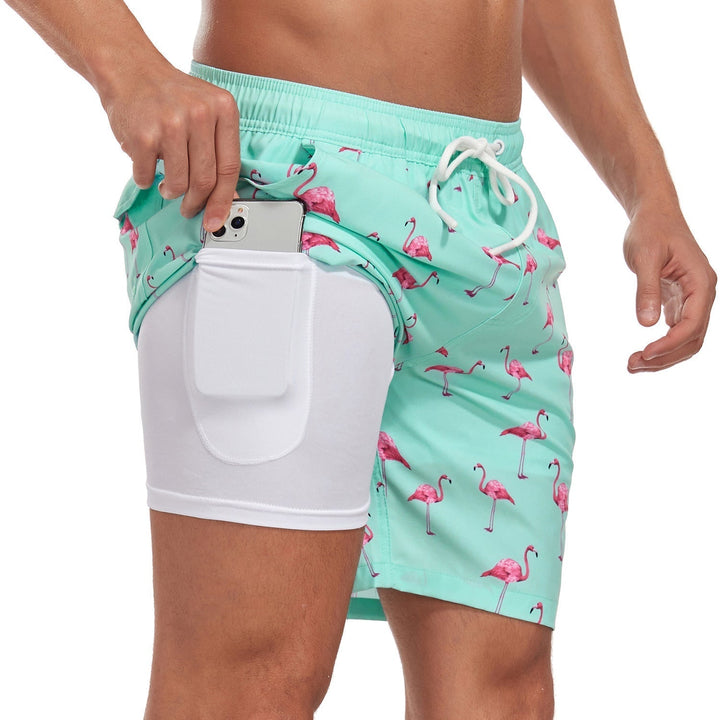 Stylish men's tropical print board shorts with quick-dry fabric & compression for comfortable summer swimwear.