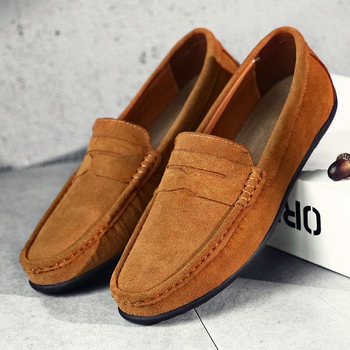 Detail of men's penny loafers, showcasing the classic strap and refined leather texture on slip-on shoes.