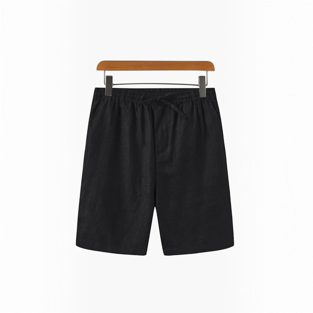 Men's relaxed fit beach shorts displayed on a sandy beach, ready for summer adventures.