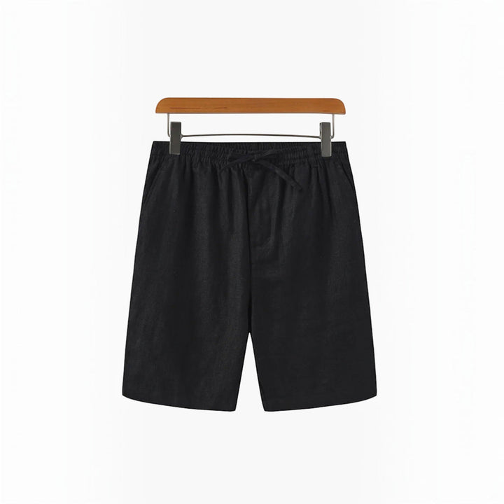 Men's relaxed fit beach shorts displayed on a sandy beach, ready for summer adventures.