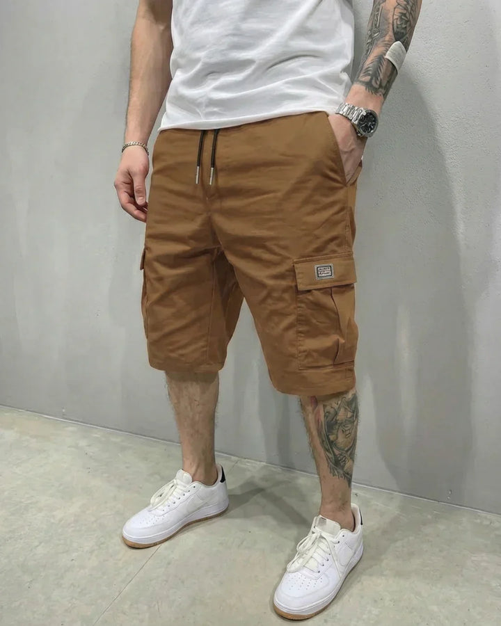Men's black cargo shorts, relaxed fit with drawstring waist & secure flap pockets, great for casual fashion.
