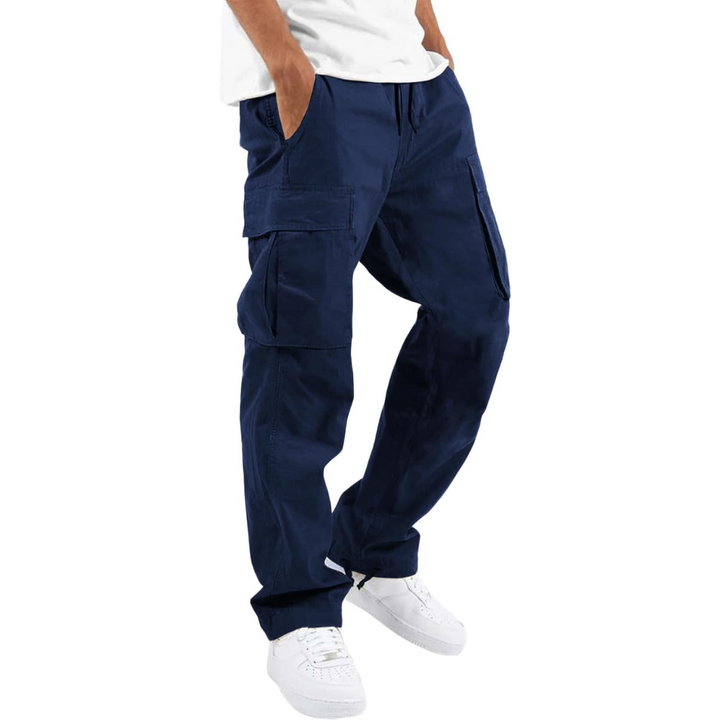 Men's relaxed fit cargo trousers in a streetwear setting, blending style with multi-pocket utility.