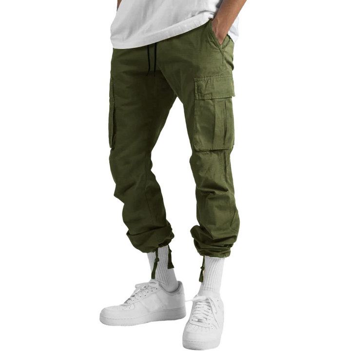 Man wearing relaxed fit cargo trousers, comfortable and stylish multi-pocket utility pants, perfect for streetwear.