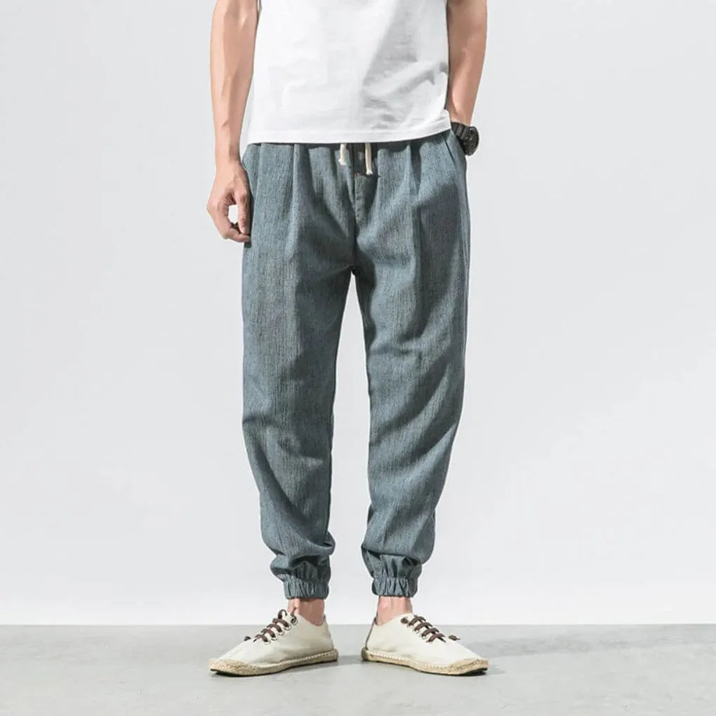 Men's relaxed fit drawstring pants, lightweight, breathable, great for versatile casual comfort.