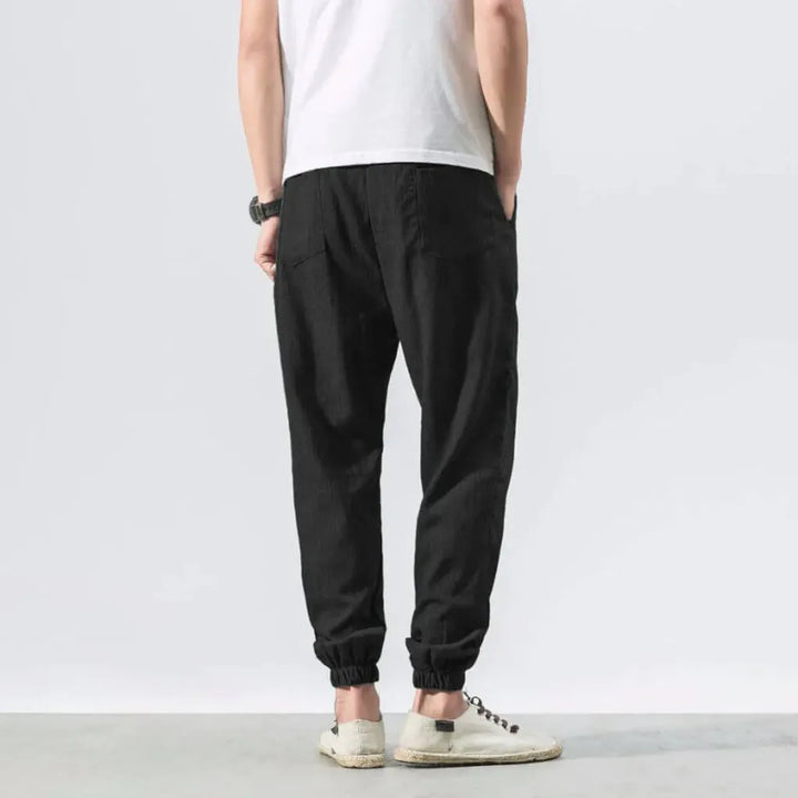 Comfortable men's relaxed fit pants featuring a drawstring waist and convenient pockets.
