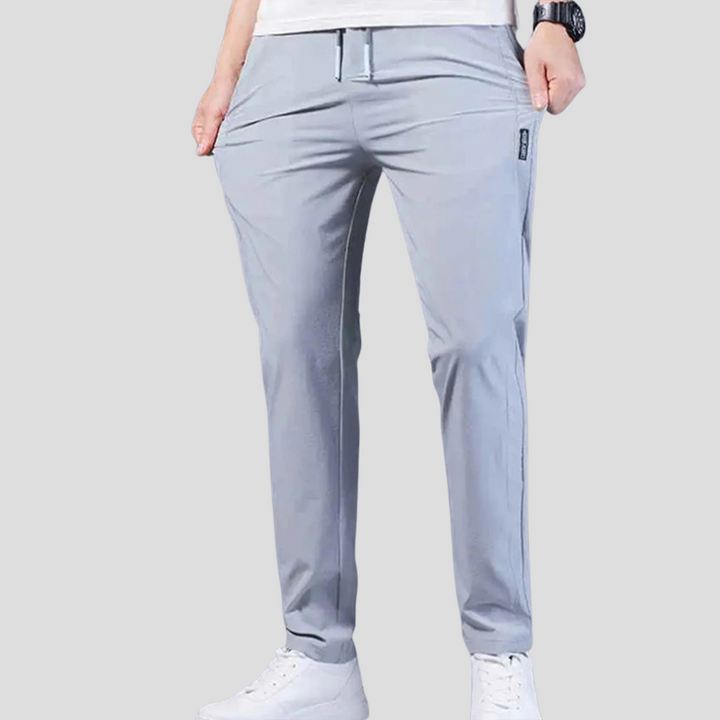 Man wearing comfortable black relaxed fit trousers, perfect for smart casual everyday wear.
