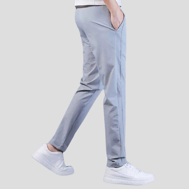 Close-up of fabric on men's gray casual trousers, highlighting their soft, relaxed fit.