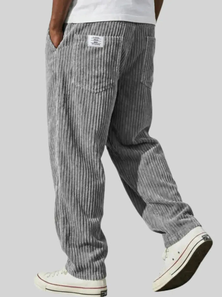Close-up of comfortable men's corduroy trousers with an elastic drawstring waist, ideal for everyday wear.
