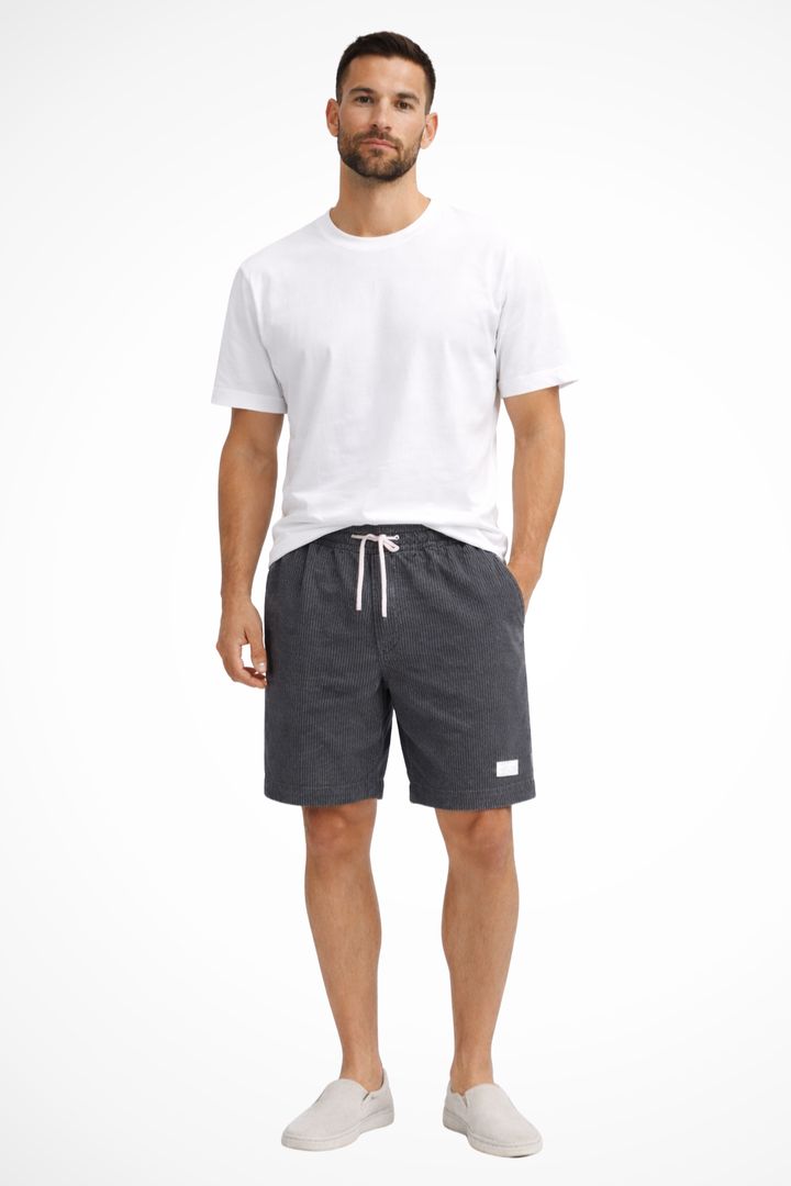 Men's relaxed fit drawstring shorts worn outdoors, perfect for summer casual activities and comfort.