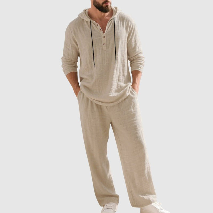 Man wearing a comfortable men's two-piece hooded set. Relaxed fit, drawstring pants, ideal for holidays.
