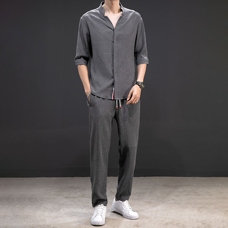 Men's relaxed linen V-neck shirt & matching pants, a comfortable two-piece set for casual summer days.