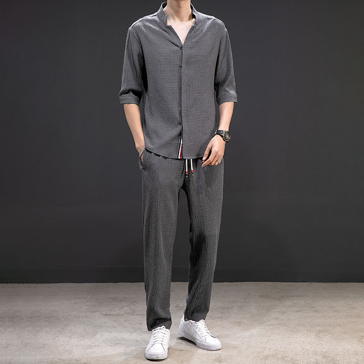 Men's relaxed linen V-neck shirt & matching pants, a comfortable two-piece set for casual summer days.