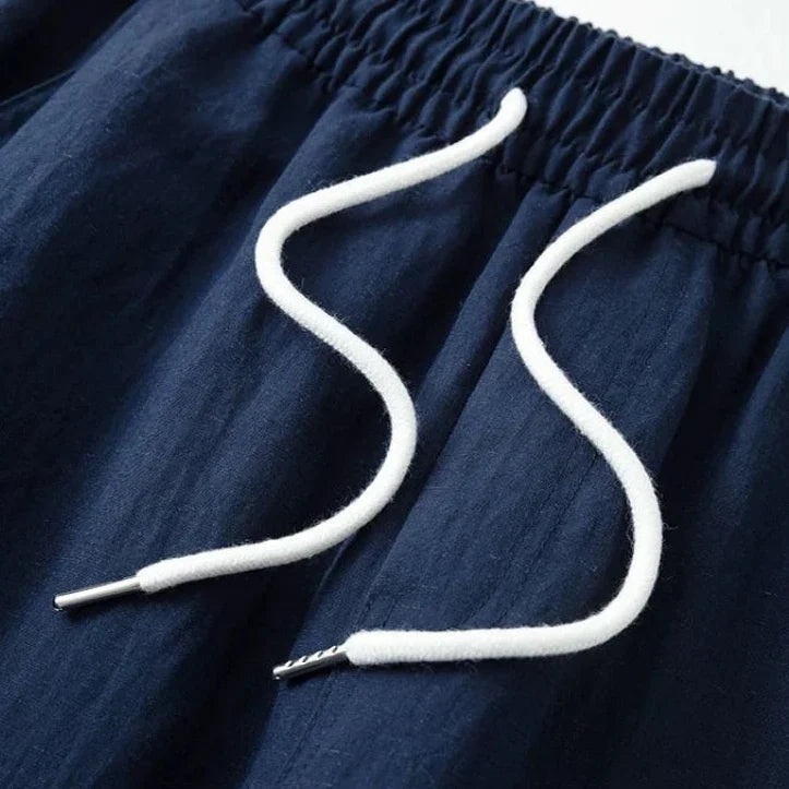 Lightweight men's wide leg linen trousers with a drawstring waist, great for beach or casual summer days.