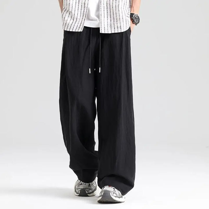 Men's comfortable wide leg linen pants, featuring a relaxed fit & drawstring waist, perfect for summer casual.