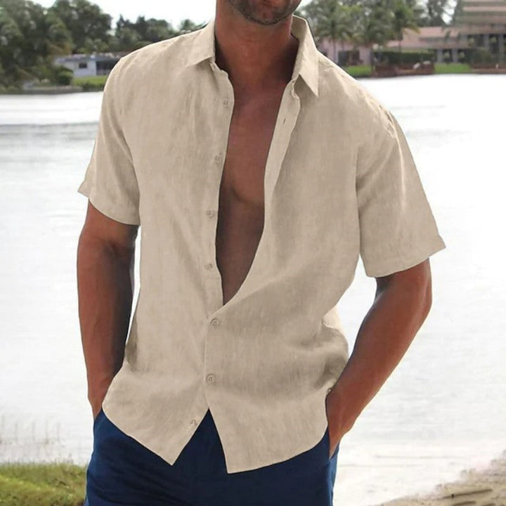 Man wearing a casual short sleeve button-up summer shirt, relaxed fit. Perfect for beach days or warm weather travel.