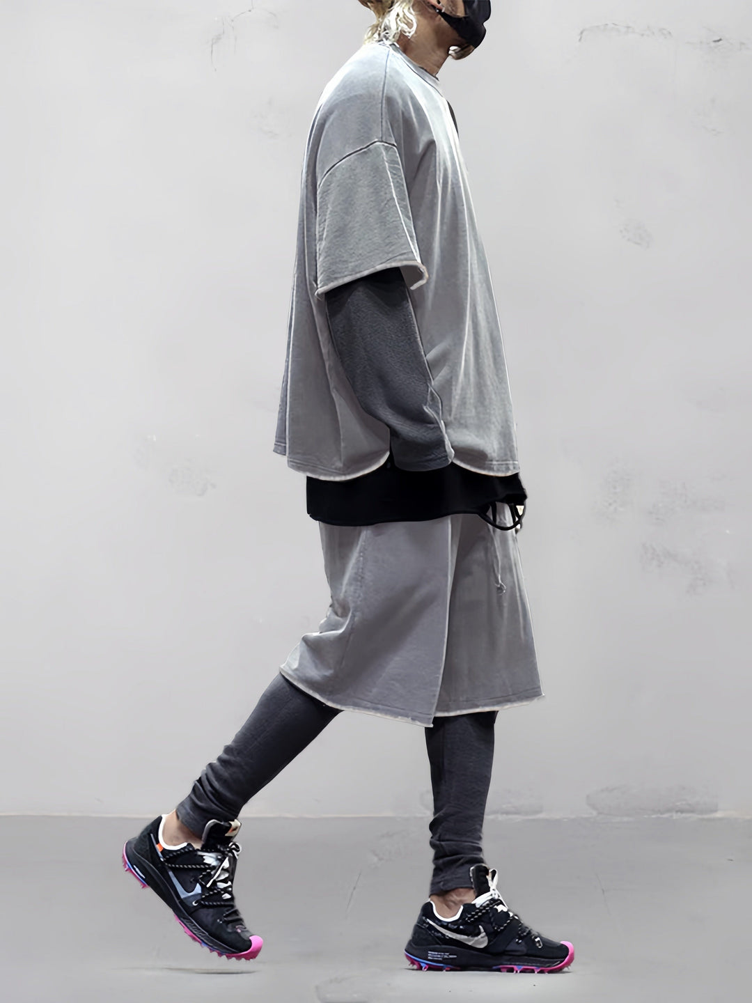 Man walking in a relaxed fit solid activewear set, ideal for casual movement & comfort.