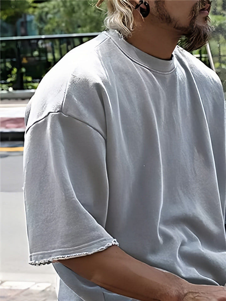 Flat lay of a solid color men's relaxed fit two-piece sports set, showcasing the design.